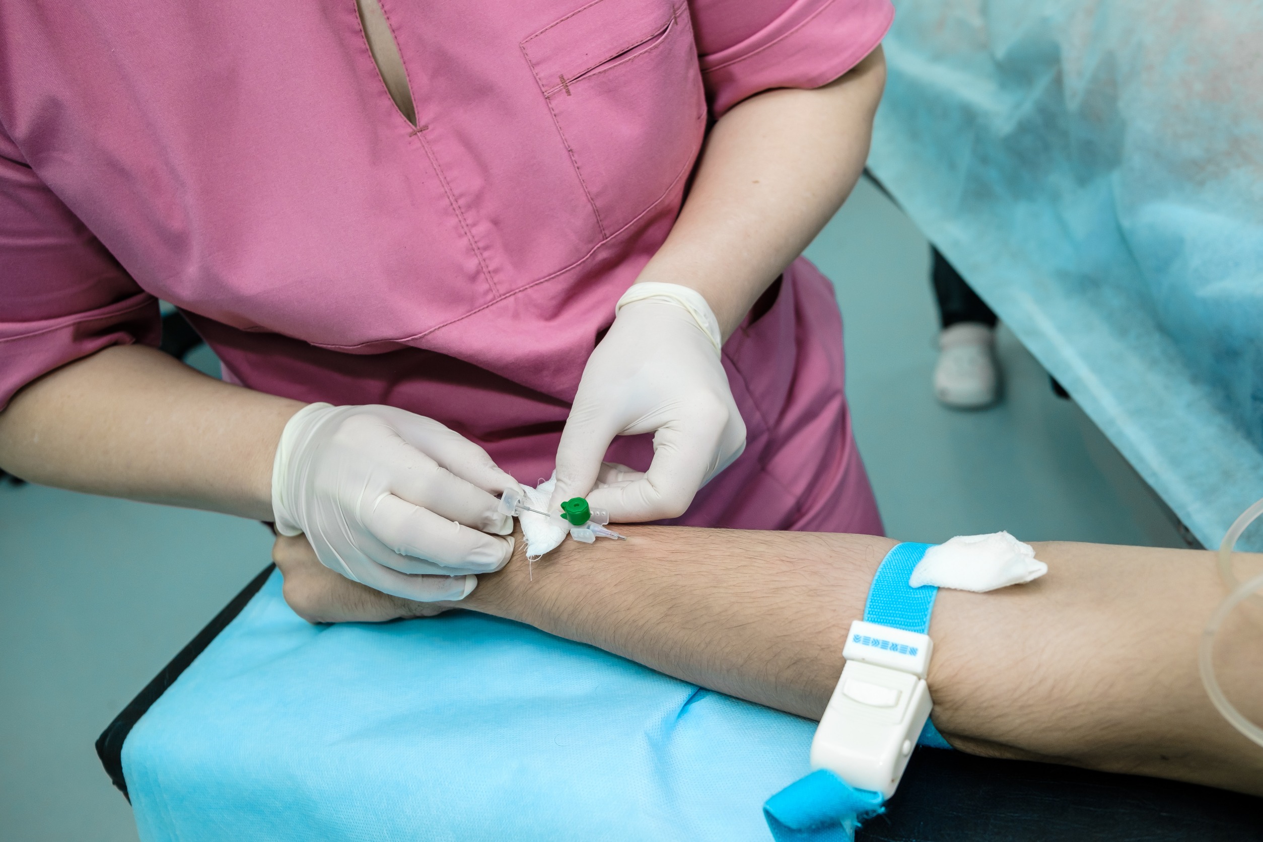 Pielęgniarka wkłuwa się pacjentowi w żyłę, aby pobrać mu próbkę krwi w celu analizy klinicznej. /Źródło: 123rf.com