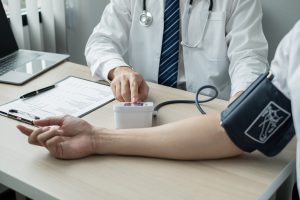 Lekarz specjalista mierzy ciśnienie pacjentowi. /Źródło: 123rf.com
