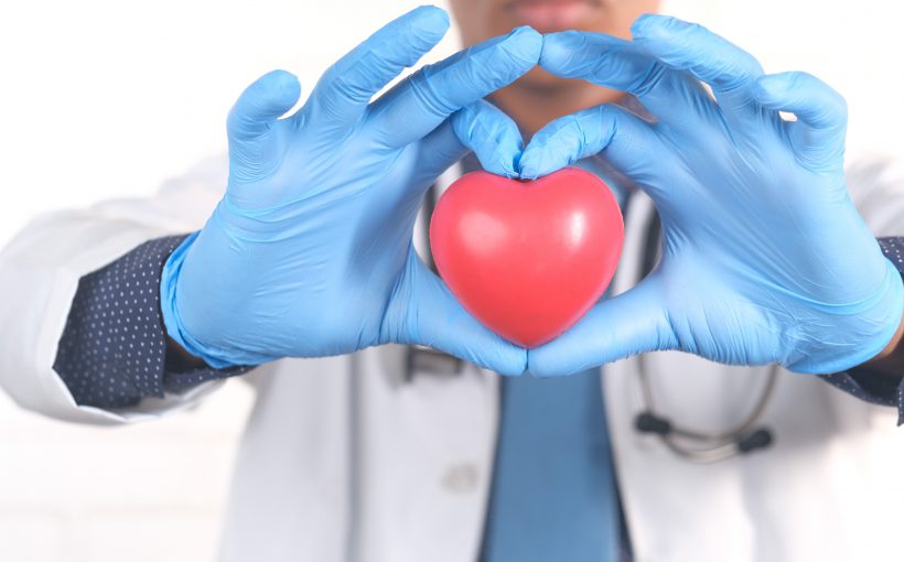 Lekarz kardiolog trzyma w dłoni sztuczne serce. /Źródło: 123rf.com