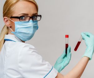 Pielęgniarka trzyma w dłoniach fiolki z próbkami krwi. Źródło: 123rf.com