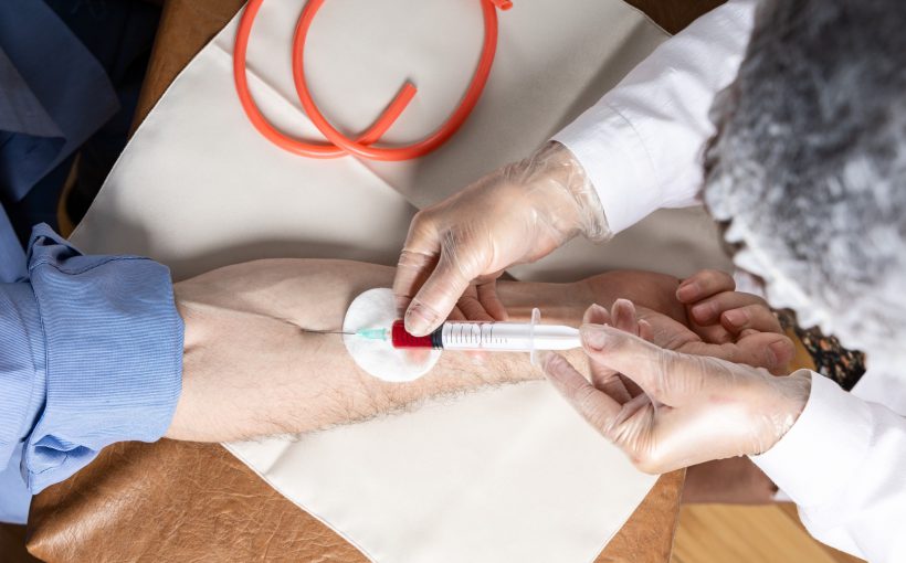 Pielęgniarz pobiera mężczyźnie krew z żyły u ręki w celu diagnostyki laboratoryjnej. Źródło: 123rf.com