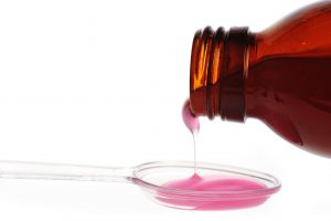 Różowy syrop wlewany na miarkę. /Źródło: 123rf.com