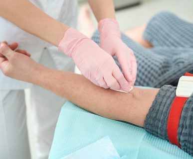 Process of taking blood from a patient for a further rejuvenating plasmolifting procedure, medical staff in protective gloves