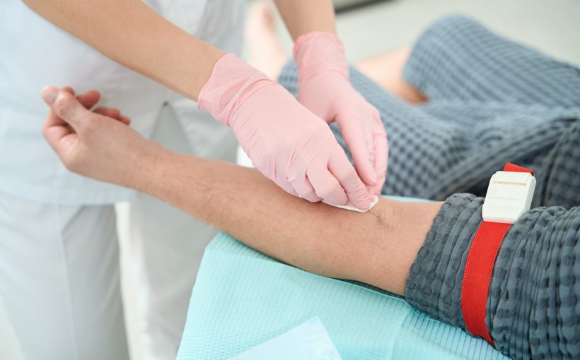 Process of taking blood from a patient for a further rejuvenating plasmolifting procedure, medical staff in protective gloves