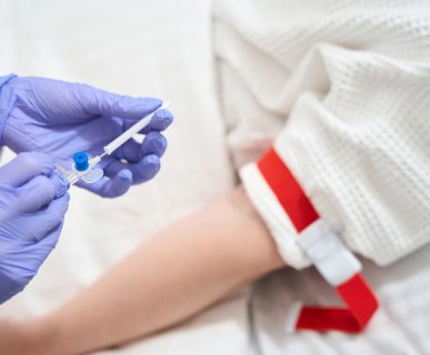 Unrecognized doctor with infusion drip in the sickroom