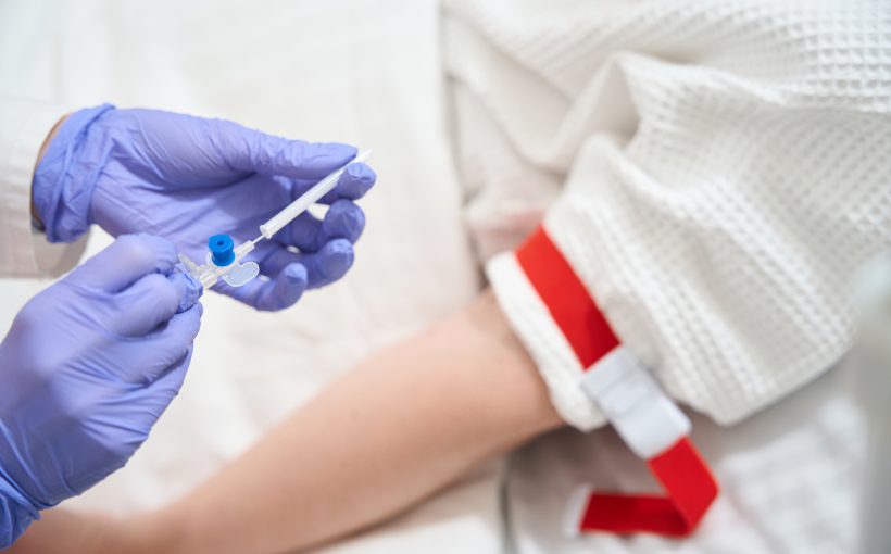 Unrecognized doctor with infusion drip in the sickroom